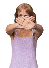 Redhead mid-aged Caucasian woman in studio doing a denial gesture