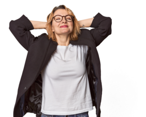 Caucasian woman in black business suit feeling confident, with hands behind the head.