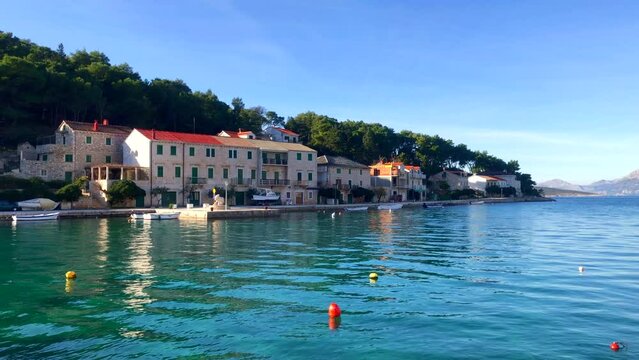 Seaside village on the Adriatic coast. View of the harbor and stone buildings in the beautiful town of Povlja, Brac Island, Croatia. Europe.