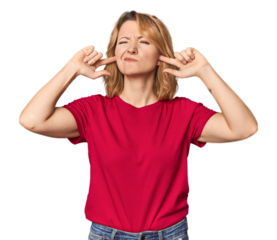 Blonde middle-aged Caucasian woman in studio covering ears with fingers, stressed and desperate by a loudly ambient.