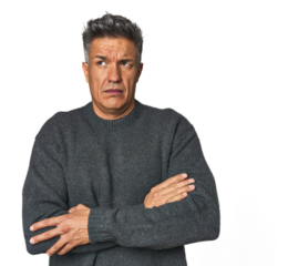 Middle-aged Latino man tired of a repetitive task.