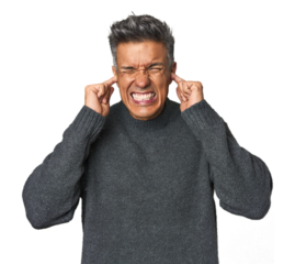 Middle-aged Latino man covering ears with hands.