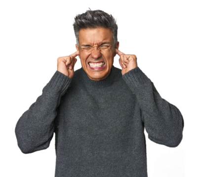 Middle-aged Latino man covering ears with hands.