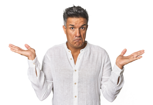 Middle-aged Latino man confused and doubtful shrugging shoulders to hold a copy space.