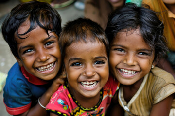 Three children's faces beaming with happiness as they participate in a workshop