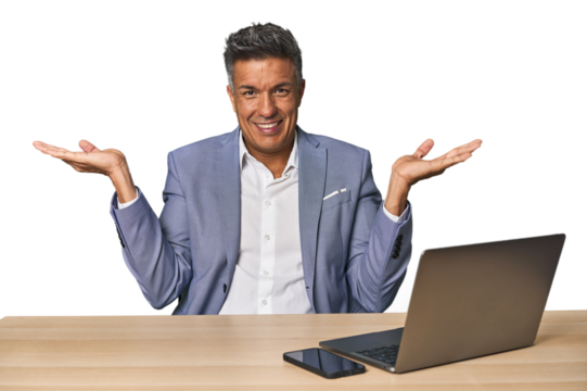 Elegant businessman at desk with laptop makes scale with arms, feels happy and confident.