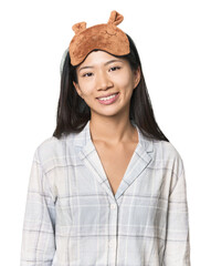 Young Chinese woman in pajamas, mask happy, smiling and cheerful.