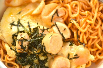 fried yakisoba Japanese noodles and cabbage topping egg and sausage dressing seaweed in sauce on...