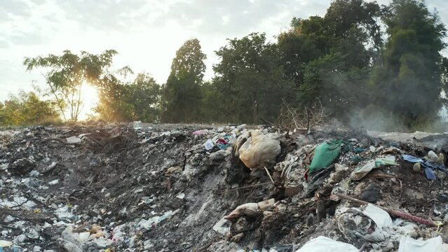 Garbage, fire burning and smoke in landfill. Also called trash, waste, rubbish. Destruction with combustion, heat, flame. Effect to environmental i.e. air pollution, toxic, disaster and global warming