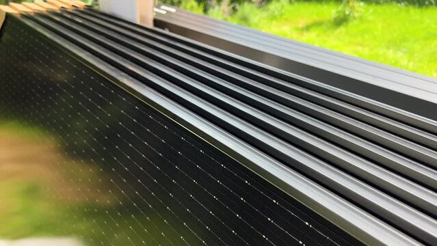 Close-up new solar panels with protective cardboard corners, ready for installation. Renewable energy technology, green living, and the implementation of solar power in residential areas.