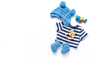 Set of baby boy dress - blue bodysuit with knitted hat and boots, top view. Kids clothing flat lay
