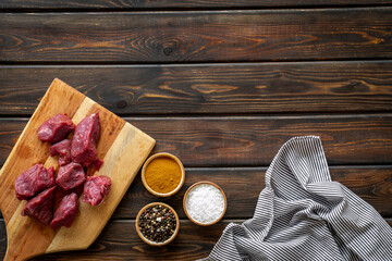 Beef meat on wooden board ready for cooking. Food background