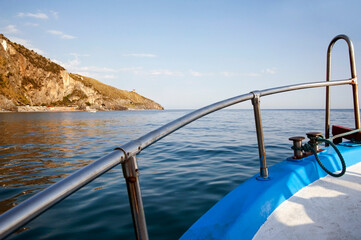 Motorboat sailing along the coast. Cruising alongshore to sightsee the cliffs