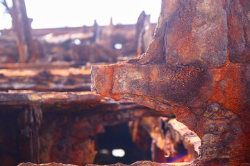Rusty crumbling piece of the SS Maheno shipwreck half buried in the sand of the 75 mile beach on the east coast of Fraser Island in Queensland, Australia - obrazy, fototapety, plakaty