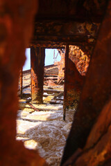 Rusty crumbling piece of the SS Maheno shipwreck half buried in the sand of the 75 mile beach on the east coast of Fraser Island in Queensland, Australia