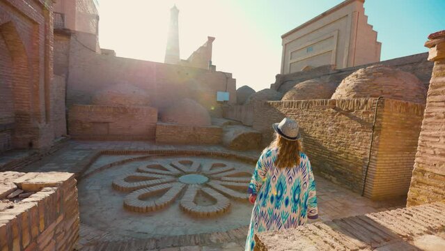Woman in ethnic dress at streets in Khiva