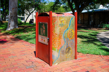 Public trash can decorated with dotted aboriginal painting on Todd Mall shopping street in downtown Alice Springs, Northern Territory, Central Australia