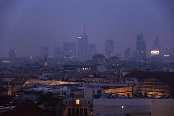 Milan - February 2024 - Milan modern city skyline in smog fog - High Levels air pollution - Rose Dusk