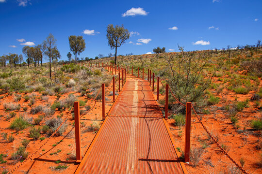 Catwalk leading to the Kata Tjuta dunes viewing area near Mount Olga, a large domed rock formation in Northern Territory, Central Australia, surrounded by bushland and steppes