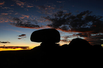 Silhouette of the Devils Marbles (Karlu Karlu in Aboriginal language) at sunset in the Australian...