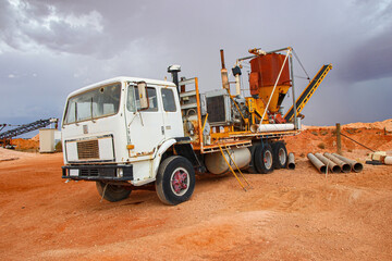 Rusty old abandoned truck with a conveyor belt in the desert outside "Tom's Working Opal Mine" along Stuart Highway in Coober Pedy, South Australia