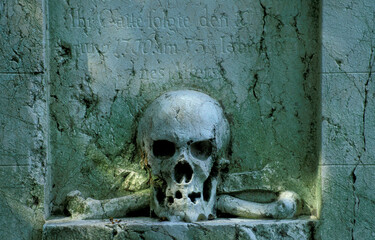 skull and crossbones on a german gravestone from 18th century, Alter Südfriedhof, Munich, Germany