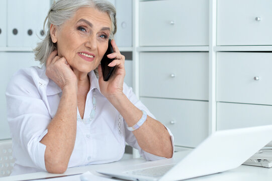 Portrait of senior business woman talking with phone
