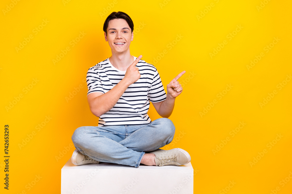 Sticker photo of positive good mood man wear striped t-shirt showing two fingers up empty space isolated yel