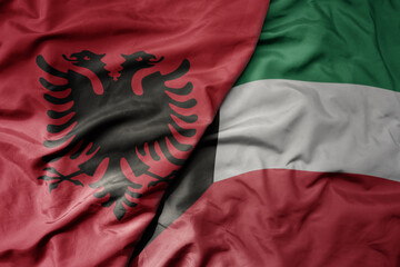 big waving national colorful flag of kuwait and national flag of albania .