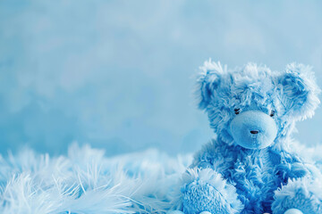 Blue background with plush toy and copy space. It's a boy backdrop with empty space for text. Baby shower or birthday invitation, party. Baby boy birth announcement.