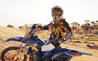Obraz premium Helmet, race and man on dirt bike in desert with adventure, adrenaline or speed in competition, Extreme sport, trick and athlete on off road motorcycle for challenge, power or danger on action course
