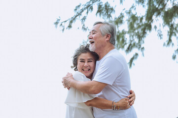 Happy asian senior retired couple, relax smiling elder man and woman enjoying with retired vacation at sea beach outdoor. Health care, Family outdoor lifestyle - 742667096