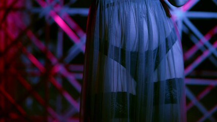 beautiful woman in erotic lingerie and black stockings dancing in dark room, closeup of belly