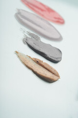 Different swatches of cosmetic products for the face and body. Scrub textures. Selfcare trend. Vertical
