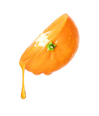 Stretched drop of juice flowing from half a tangerine close up, isolated on white background