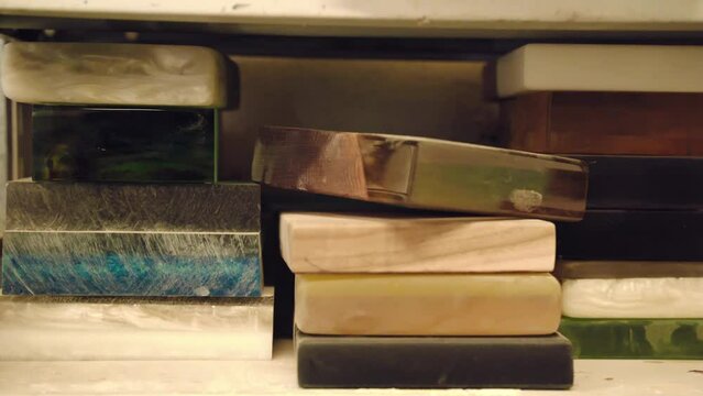 Cut and polished samples of wood, epoxy resin, or wood mixed with epoxy resin in workshop, unique samples of trendy furniture design in carpentry workshop, wood samples selection for home interior
