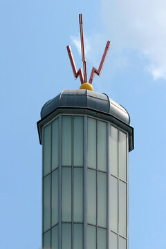 Three sparks, a symbol of electrical discharge on a lightning rod on a rooftop