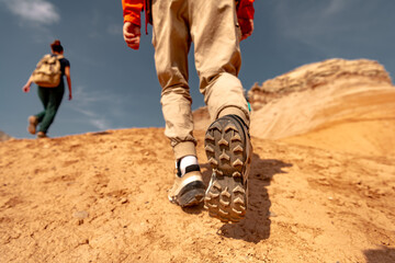 Close up photo of hiker legs and boots is walking uphill