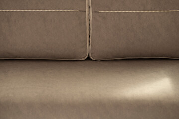 Interior sofa with pillows. A soft, comfortable sofa for relaxing in brown-beige cocoa-colored...