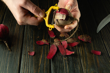 Cooking a vegetable dish with red beets by the hands of a cook on a hotel kitchen table. Vegetable...