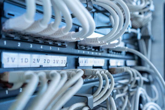 Close up of networks server rack with internet patch cord cables connected to patch panel.