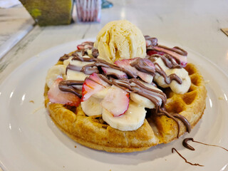 View of Decadent Waffle with Vanilla Ice Cream and Fresh Strawberries