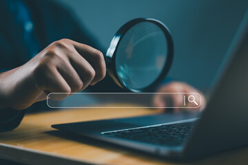 Businessman use magnifying glass Search On Virtual Screen Data Search Technology Search Engine...