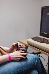 Person playing an old video game on a vintage console