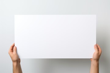 Person holding up a white paper for a creative concept idea - obrazy, fototapety, plakaty