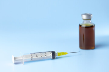 syringe for injectable medication on blue background