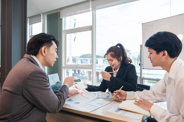 The Asian business team brainstormed and discussed work planning. Financial or statistical figures of the company in the conference room