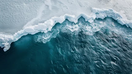 Foto op Canvas A big icefield in the water as seen from the top, a chunk of ice is falling off an iceberg into the water causing a big wave because of climate change © NordicShieldMaidens