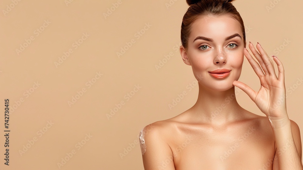 Wall mural Beauty Spa Woman with perfect skin Portrait. Beautiful Brunette Spa Girl showing empty copy space on the open hand palm for text. Proposing a product. Gestures for advertisement. Beige background - Wall murals