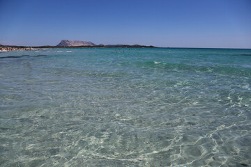 Turquoise sea water and Tavolara Island view in La Cinta Beach in San Teodoro, Sardinia, Italy	